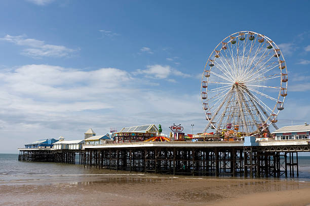 Seaside pier, Blackpool "Traditional Victorian seaside pier. This is the Central Pier with fairground rides in the seaside town of Blackpool, Lancashire, UK." lancashire stock pictures, royalty-free photos & images