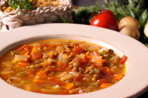Bowl of vegetable soup and its ingredients - closeup