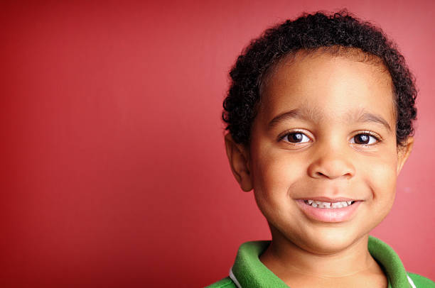 istock Happy Little Boy Smiling on Red Background 173900588