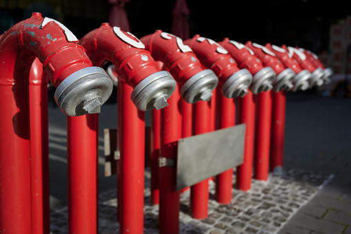 Nine modern fire hydrants.