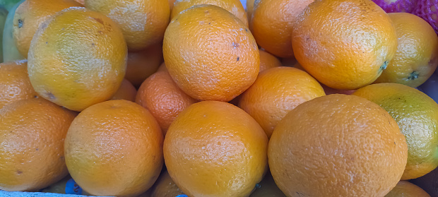 bunches of oranges on market stall