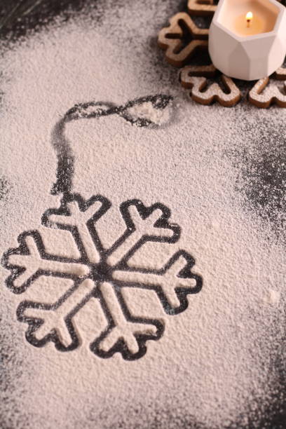istock photo a traditional Christmas decoration graces the table, featuring snowflake pattern. Winter's warmth and charm are beautifully captured in this photography with a candle's soft glow 1739011637