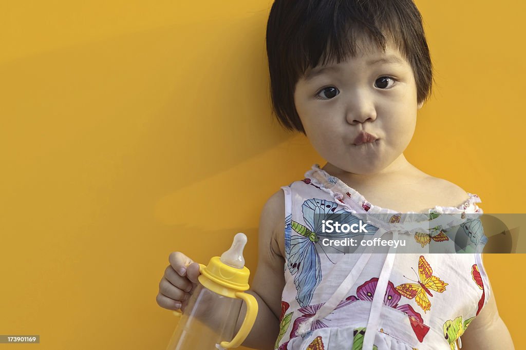 Asian baby holding a bottle This is a asian baby. 18-23 Months Stock Photo