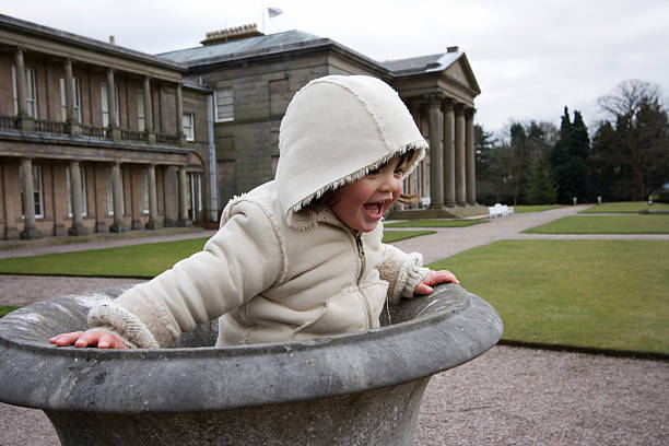 Toddler playing in garden urn