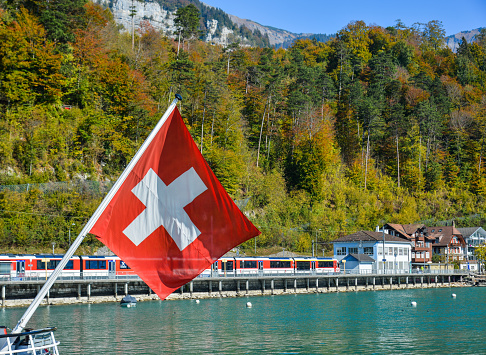 Swiss flag in tourist boat on Lake Brienz. Brienz  is a lake just north of the Alps, in the canton of Berne.