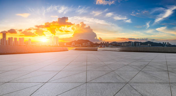 istock Empty square floors and skyline with buildings at sunset 1739026876