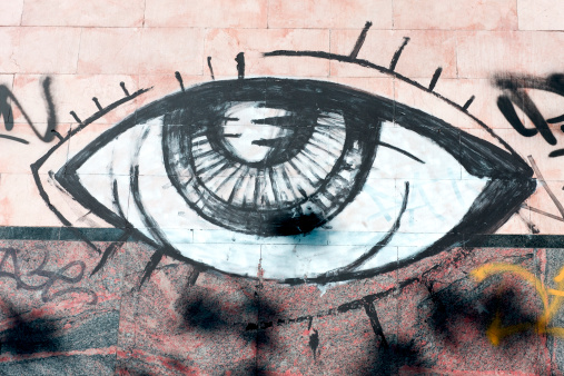 Eye painted in a wall. Vandalism in the city______________________________