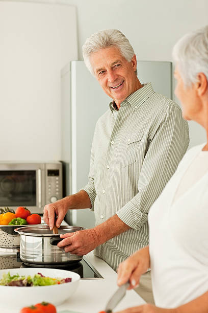 istock Senior couple preparing food at the kitchen 173903433