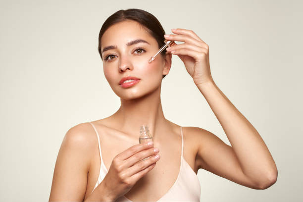 istock Young beautiful woman applying face serum 1739034331