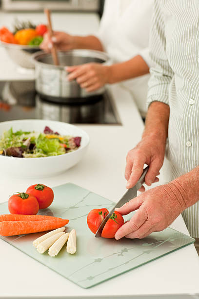 istock senior couple preparing food at the kitchen 173903436