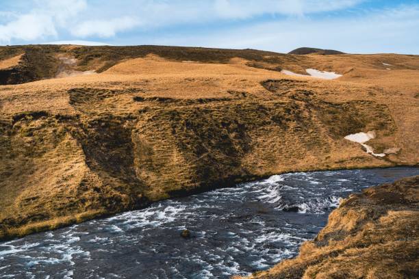 istock brown mountain with a river, dirt and grass on both sides 1739034802