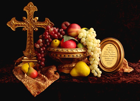 Still life with cross, fruit, and framed scripture from Galatians 5:22.(very warm and subdued lighting to emulate an old style oil painting)