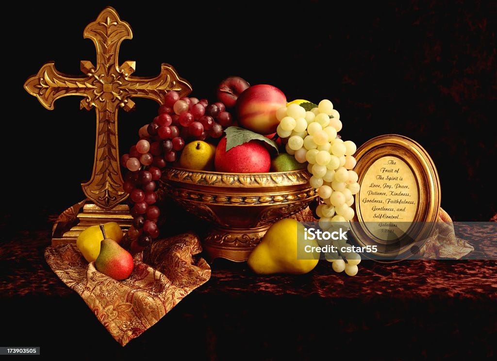 Religious: Fruit of the Spirit Still Life Still life with cross, fruit, and framed scripture from Galatians 5:22.(very warm and subdued lighting to emulate an old style oil painting) Fruit Stock Photo