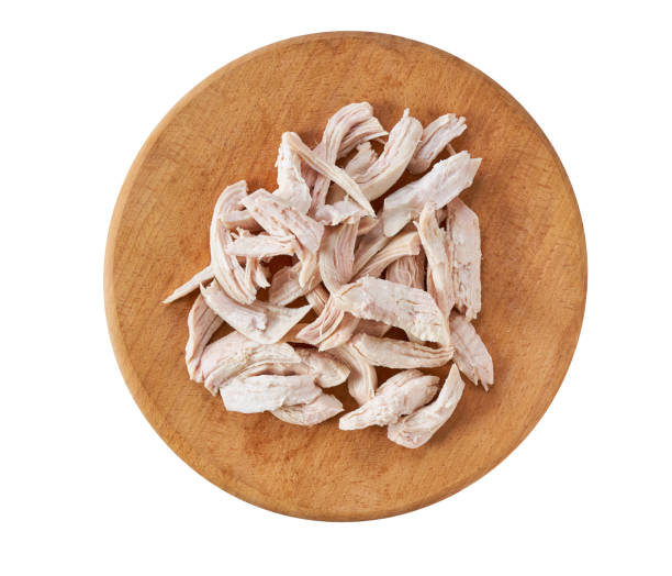 istock Boiled shredded chicken meat on a cutting board isolated on white background, top view. 1739038991