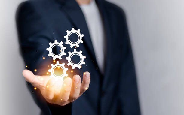 istock Businessman with gears icon on virtual screen. Innovative gear icon with network connection. Creative ideas and imagination and inspiration. 1739039124