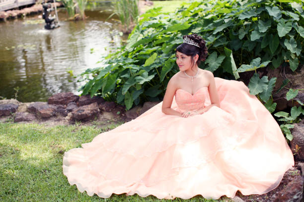 Beautiful Quinceanera Young teen wearing a quinceanera dress on her 15th birthday. quinceanera stock pictures, royalty-free photos & images