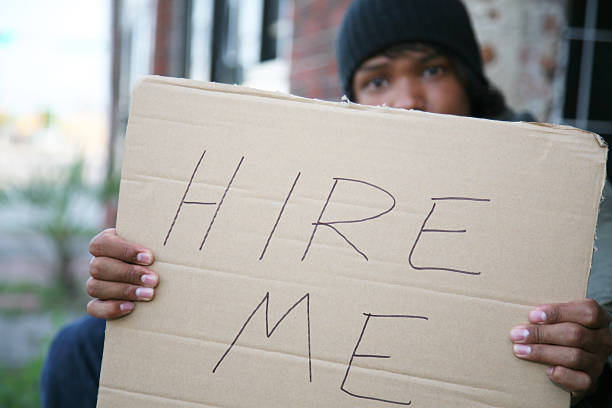 istock Large Hire Me Sign Held by unemployed man on street 173904036