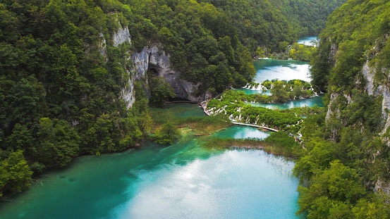 Waterfall in Plitvice Lakes in Croatia. A cascade of 16 lakes connected by waterfalls and a limestone canyon. The waters flowing over the chalk. Popular tourist attraction. Natural landmark.