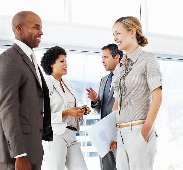 istock Business colleagues discussing and smiling 173904348