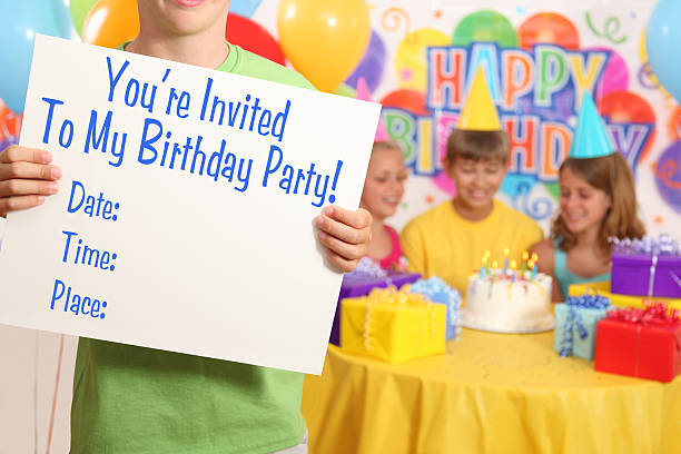Young boy holding an invitation at a birthday party.  Text can be easily changed or added in Photoshop.  Similar image available for girl's party (see lightbox).