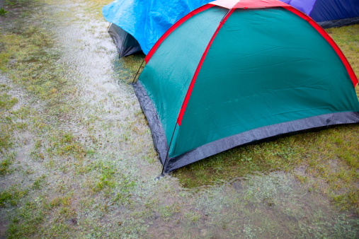 Tents on a lawn under water at a music festival