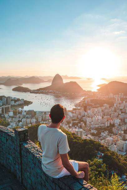 person watching the sunrise in rio de janeiro brazil mirante dona marta rio de janeiro brazil tourists at christ the redeemer statue rio de janeiro brazil stock pictures, royalty-free photos & images