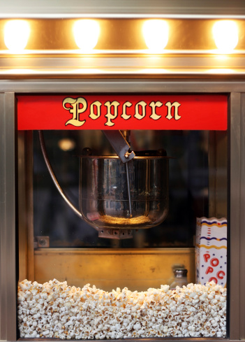 An old style popcorn machine with popcorns inside