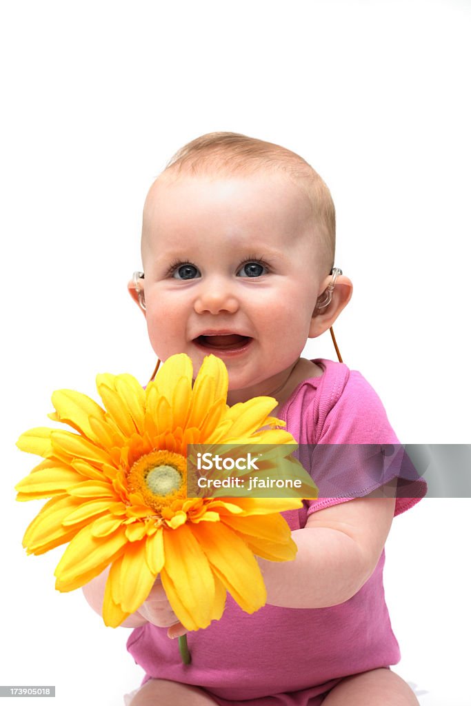 Süßes baby-Mädchen in Rosa mit Blume - Lizenzfrei Hörgerät Stock-Foto