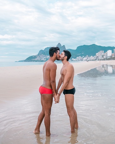 gay couple kissing at the beach in rio de janeiro brazil during pride