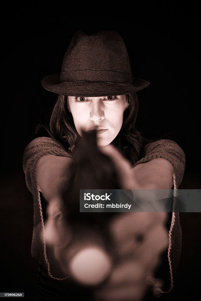 Agent in dark Woman agent pointing gun. Taken on Uber'lpse Berlin 2009.  Adult Stock Photo