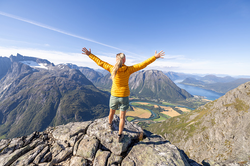 Young woman hiking in a beautiful scenery in Summer enjoying nature and the outdoors.
Norway