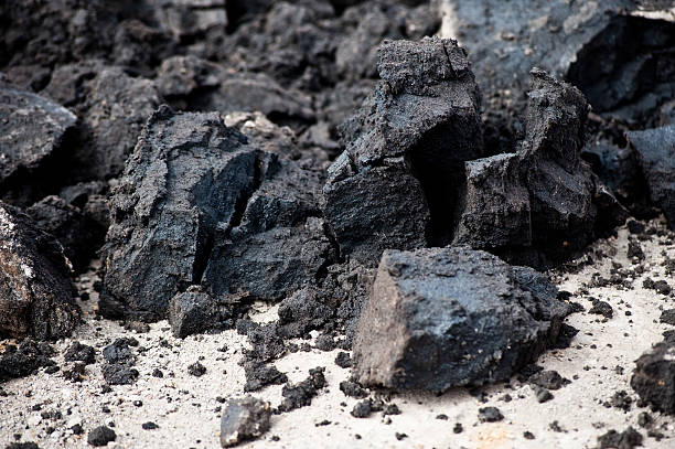 Closeup of black deposits of oil sands Raw oil sand, straight of out the ground. oilsands stock pictures, royalty-free photos & images