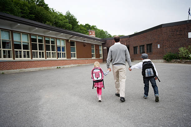 Child and Man Walking to School stock photo