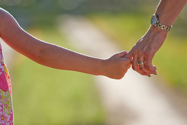 istock Mom and Daughter Holding Hands 173906931