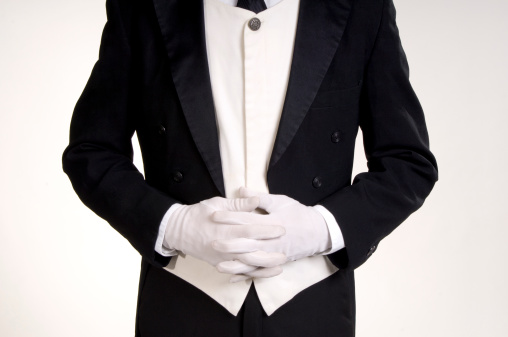 waiter stands with hands clasped