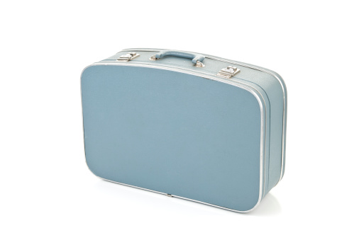 Worn blue suitcase isolated on white background.