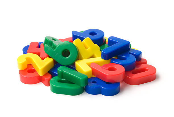 Heap of numbers Heap of toy magnetic numbers isolated on white. More related images in Zocha`s objects number magnet stock pictures, royalty-free photos & images