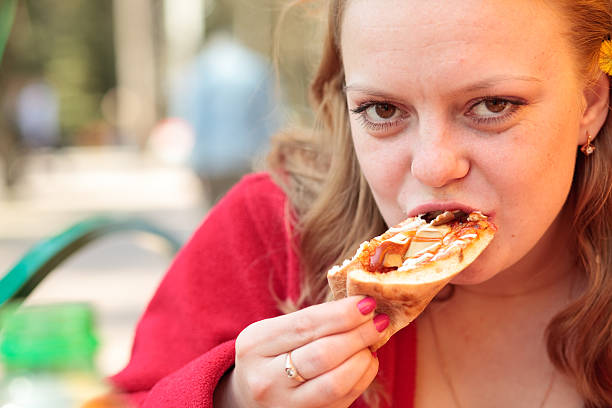 istock girl eating pizza 173908881