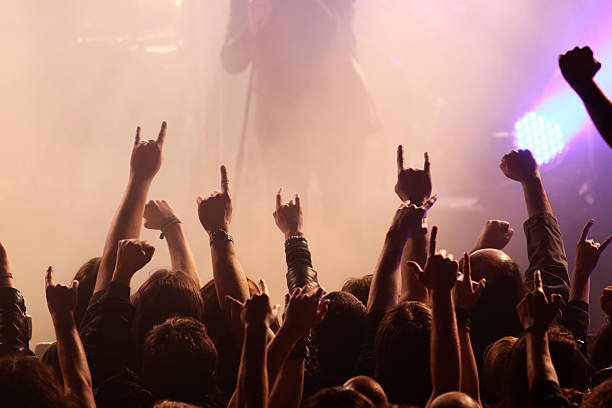 istock A crowd at a concert lifting rock hands 173909365