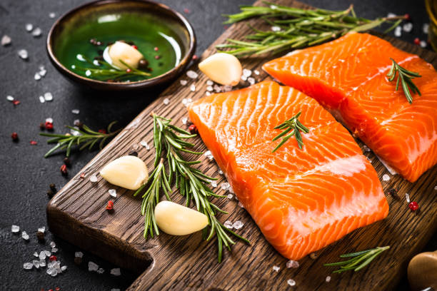 istock Salmon fish with ingredients at black table. 1739096538