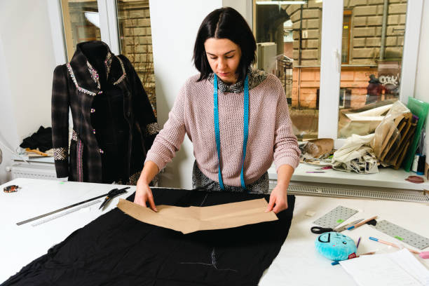 istock Seamstress works in the tailoring workshop with fabric and tools on the table 1739097793