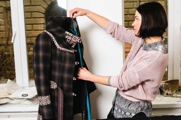 istock Seamstress works in the tailoring workshop with fabric and tools on the table 1739098345