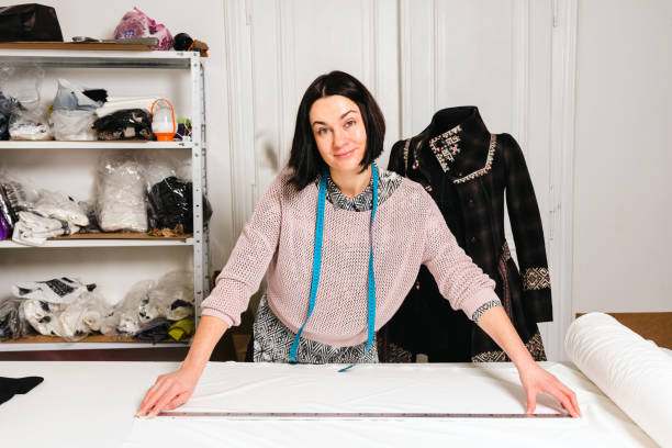 istock Seamstress works in the tailoring workshop with fabric and tools on the table 1739099026