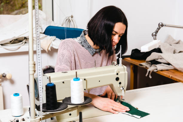 istock Seamstress works in the tailoring workshop with fabric and tools on the table 1739099680