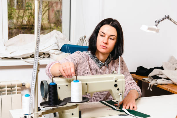 istock Seamstress works in the tailoring workshop with fabric and tools on the table 1739099782