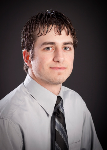 Head shot of an attractive young man wearing a dress shirt and tie.