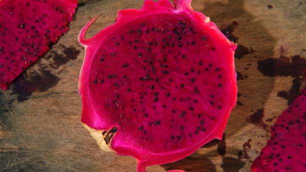 istock dragon fruit or ( buah naga, Pitaya, Pithaya, Pitaya Roja, Kamalam, Selenicereus undatus, Hylocereus polyrhizus ) on a wooden board 1739104811