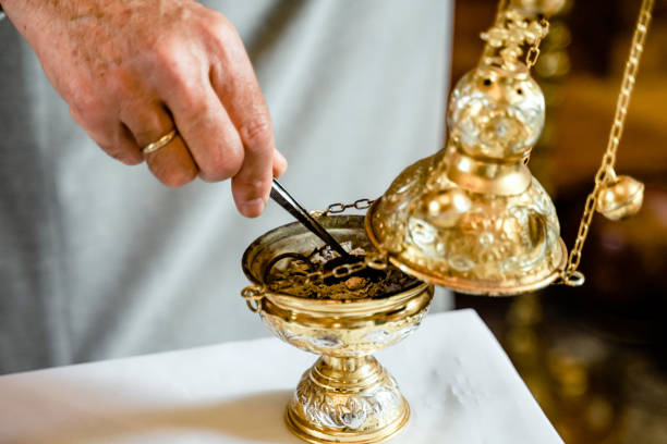 istock Hand of priest putting incense in censer 1739106926
