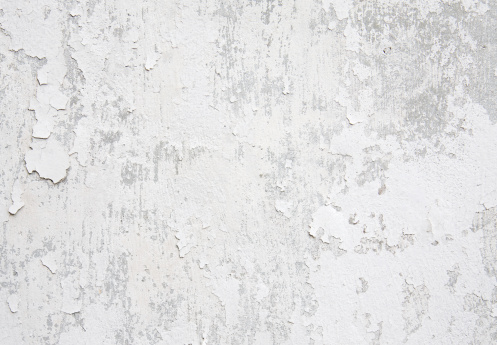 White weathered wall with flaking paint background/texture.