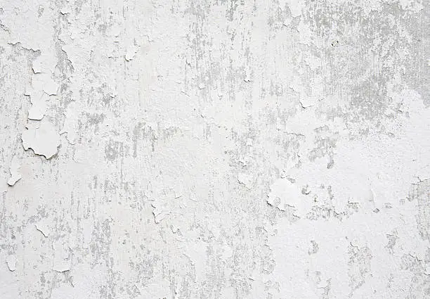 White weathered wall with flaking paint background/texture.